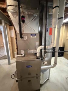 Carrier gas furnace with PVC venting installed in a basement in Sewell, NJ.