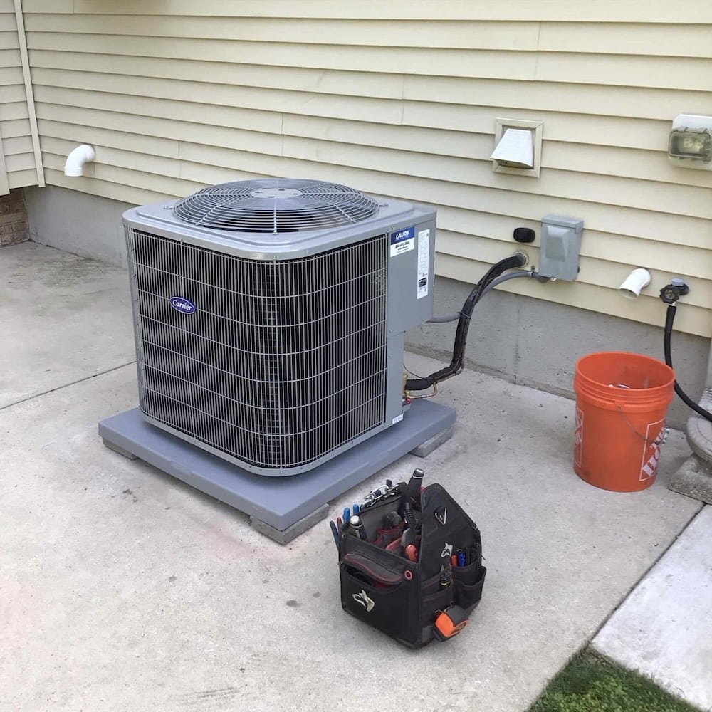 AC repair technician tools next to condenser unit at a home in Washington Township, NJ