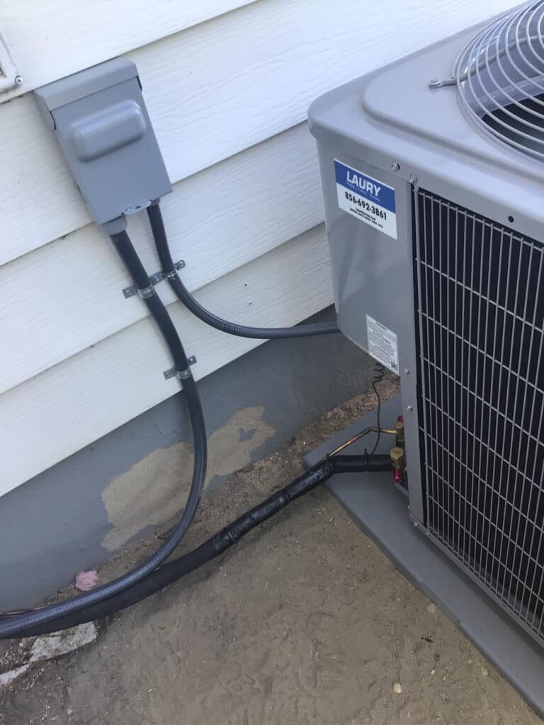 Outdoor air conditioning unit installed by Laury Heating & Cooling in Vineland NJ for residential cooling service