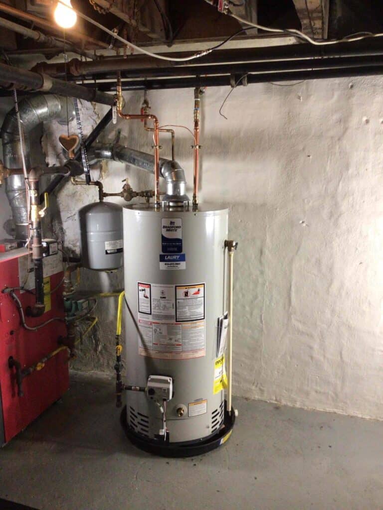 Laury Heating water heater repair in Vineland NJ showing tank-style residential unit in basement