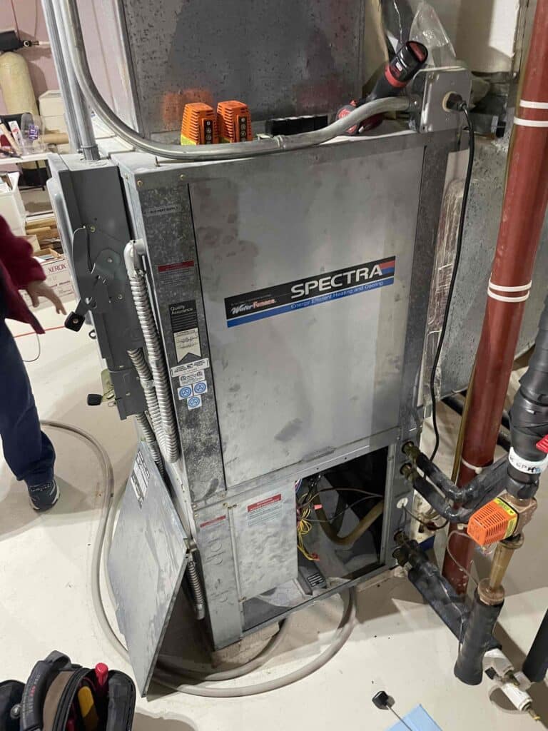 Geothermal heating and cooling system undergoing professional repair by a certified technician in South Jersey.