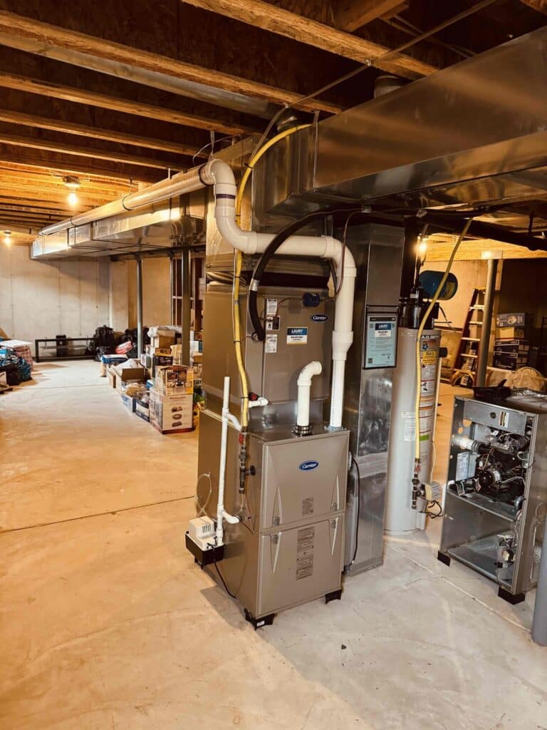 Professional HVAC system installation in a basement of a Mays Landing, NJ home, showing furnace and ductwork.