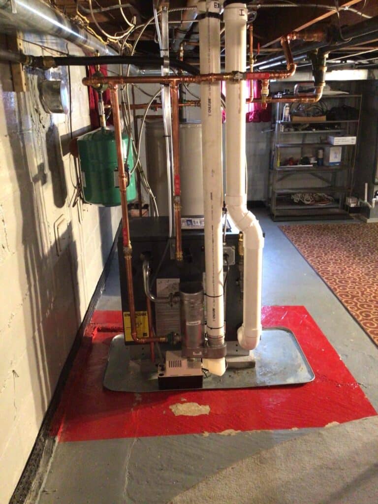 Side view of high-efficiency boiler installation by Laury Heating in South Jersey home basement