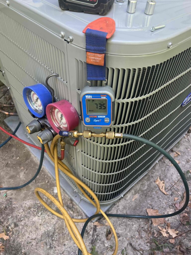 Air conditioning unit being serviced with gauges and tools during an AC repair in South Jersey.