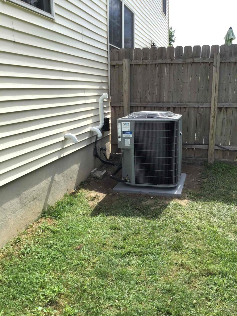 New outdoor AC condenser unit installed as part of a full air conditioning replacement.