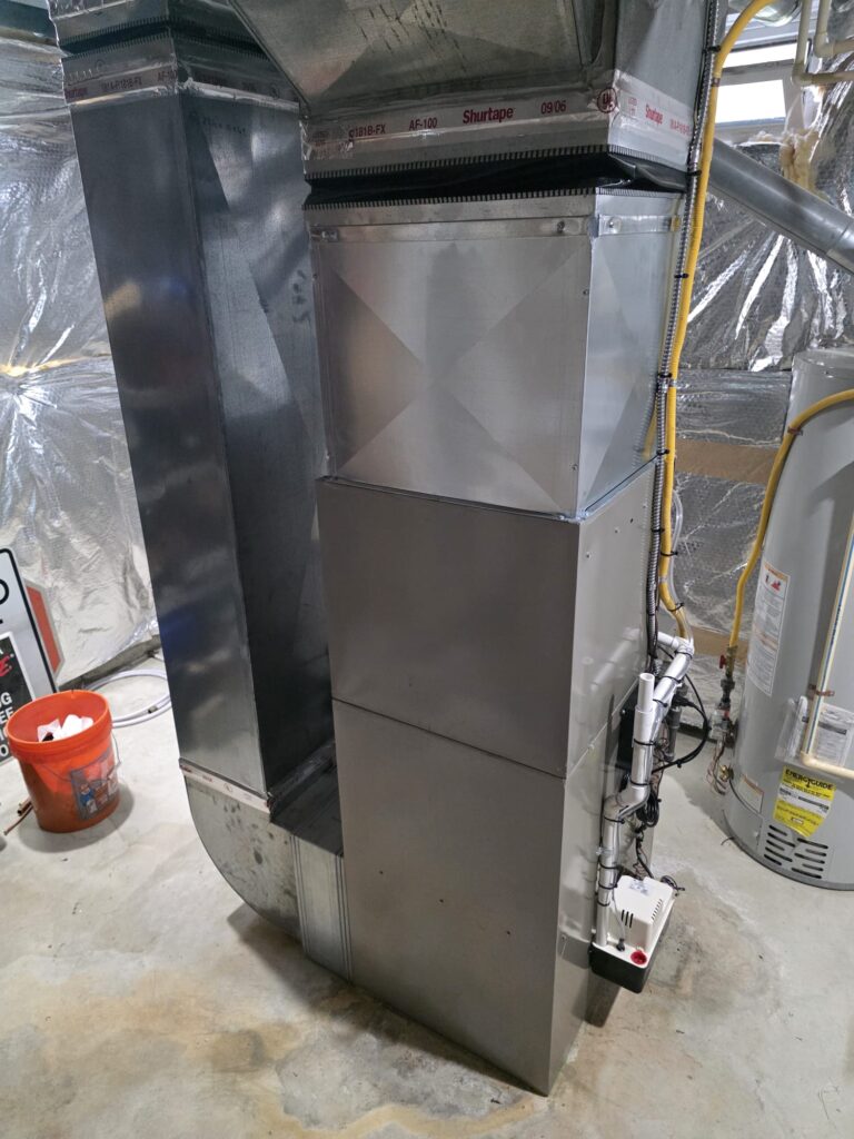Rear view of a newly installed residential furnace with ductwork