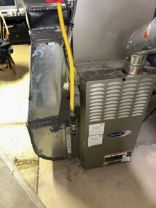 Basement furnace being inspected during an emergency heating repair in a South Jersey home.
