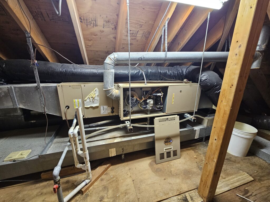 Old attic furnace needing to be replaced.