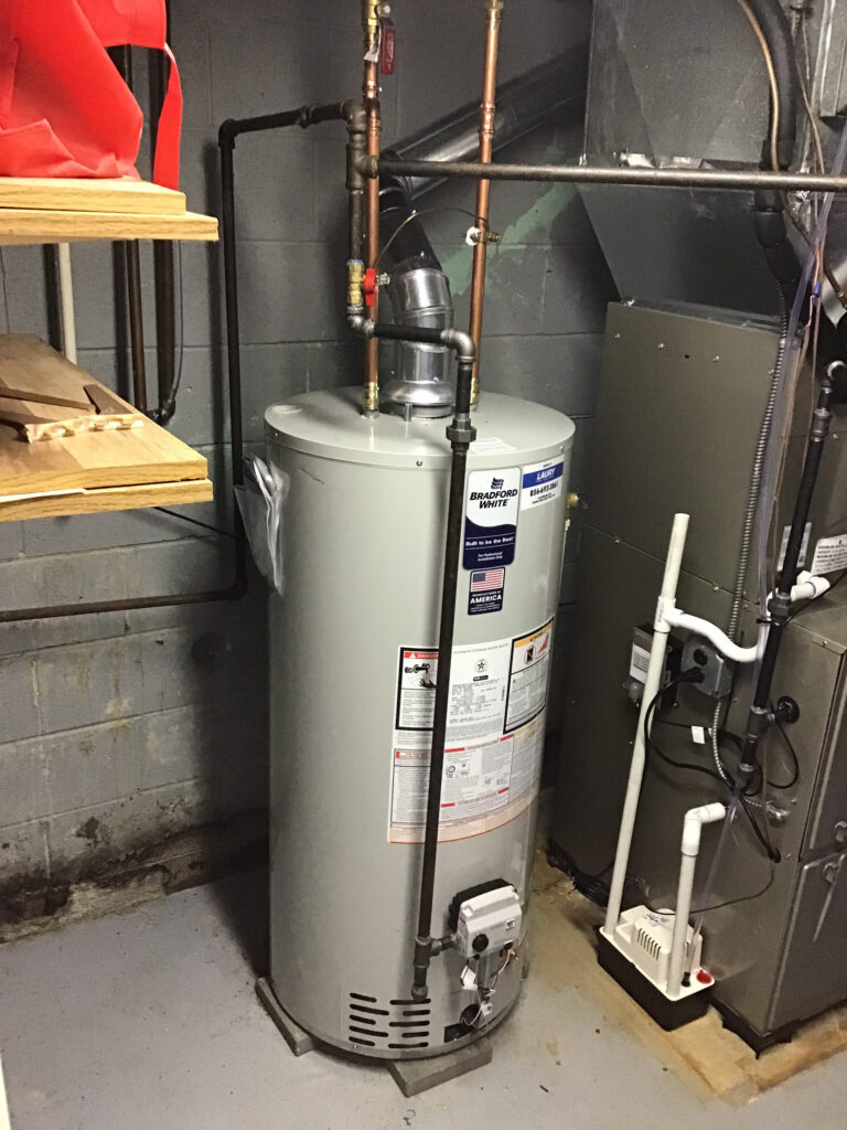 Professional water heater installation in a residential utility space