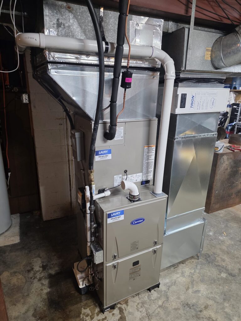 Technician performing furnace maintenance during a heating system tune-up