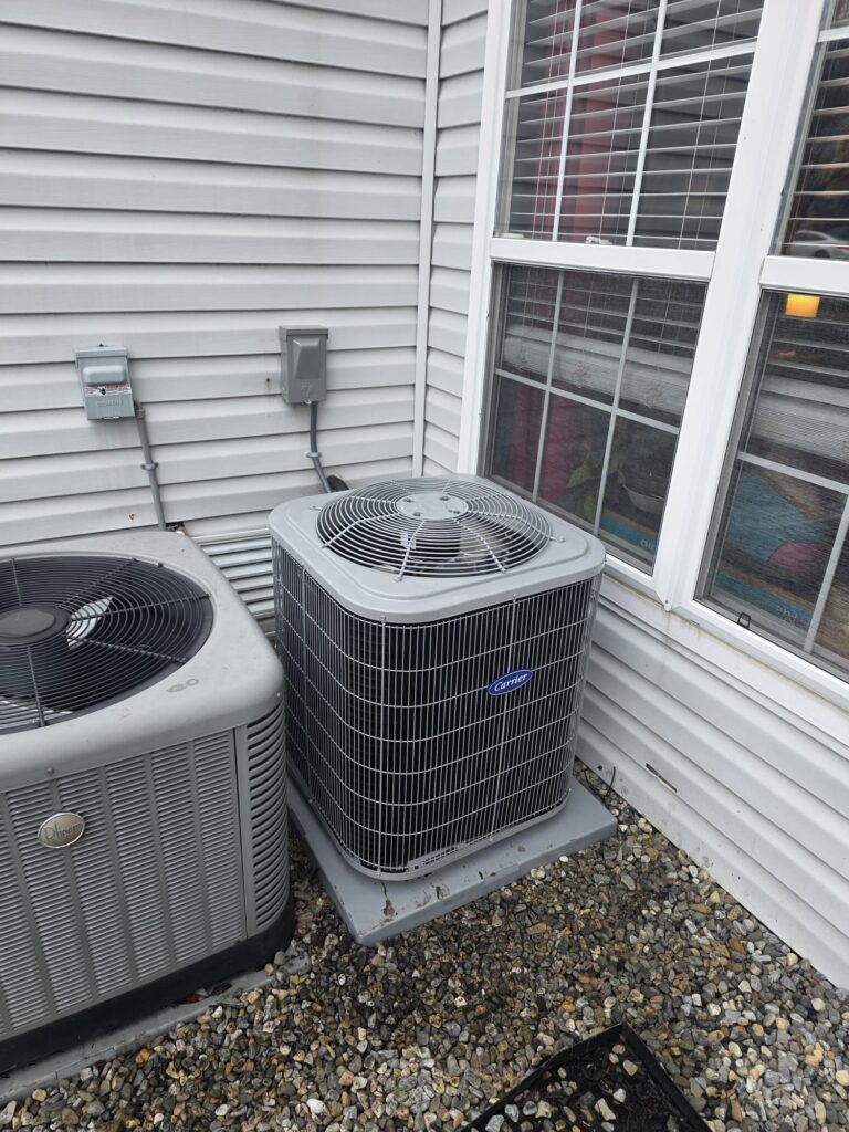Outdoor air conditioner units next to home in Vineland NJ during AC repair service