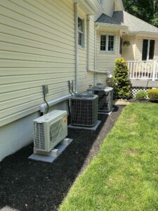 Multiple single-stage Carrier air conditioning units installed outside a New Jersey home
