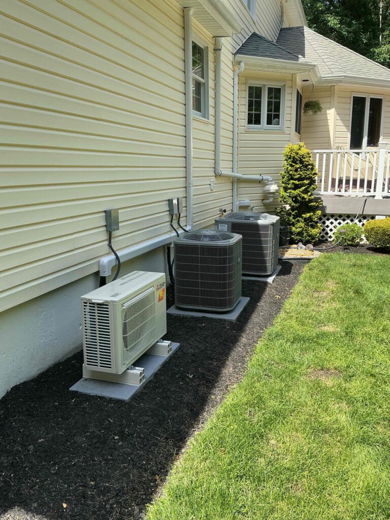 Multiple single-stage Carrier air conditioning units installed outside a New Jersey home