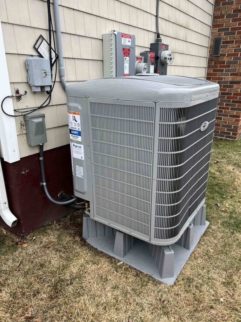 Variable-speed Carrier air conditioning unit installed outside a New Jersey home