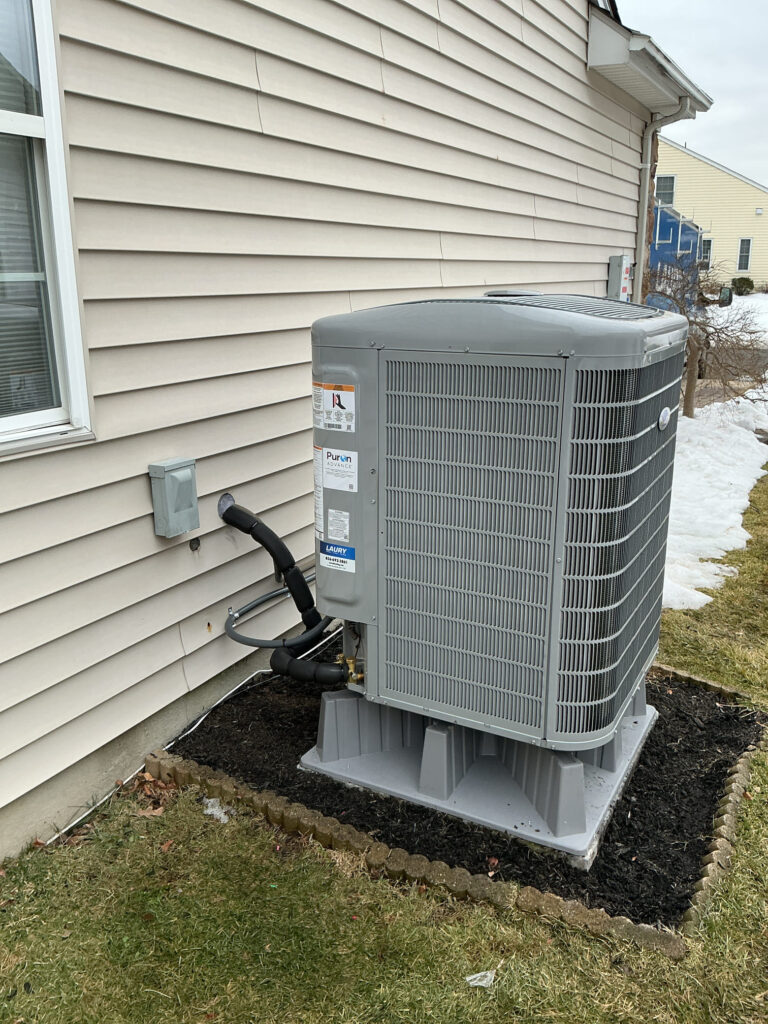 Variable-speed Carrier heat pump installed outside a South Jersey home