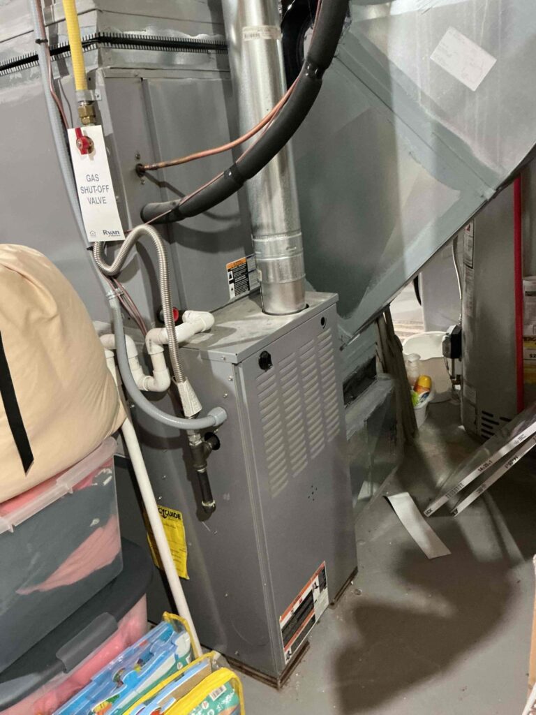 Laury technician inspecting an older furnace in a South Jersey home