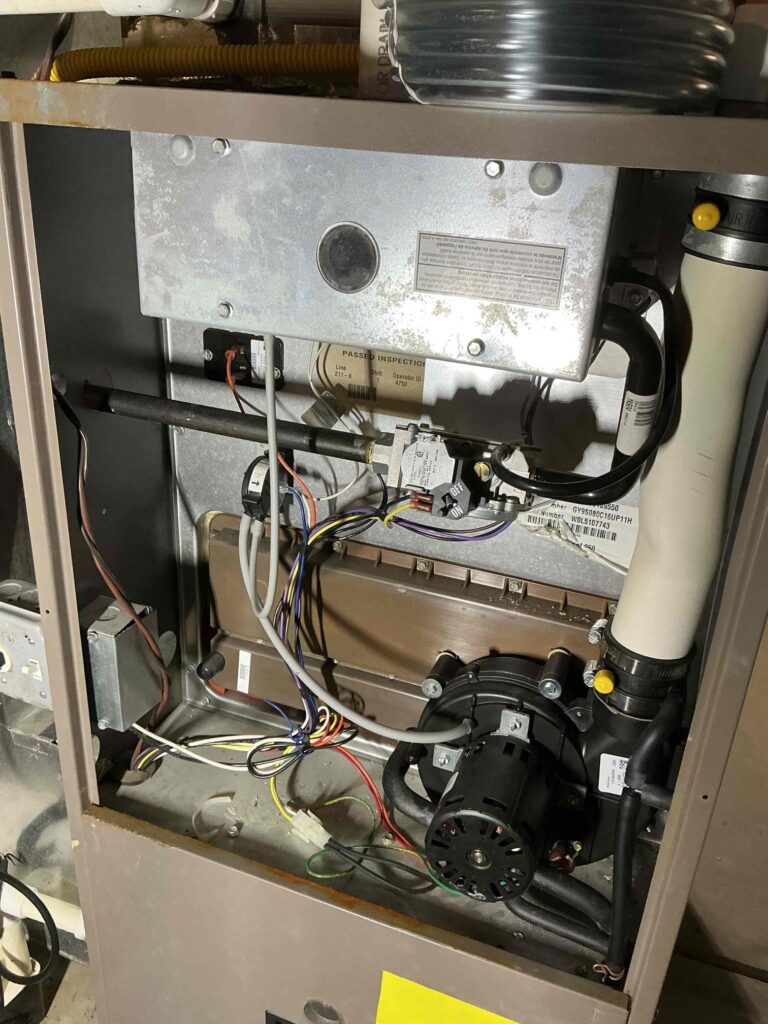 Open furnace cabinet during a repair visit in Sewell, NJ