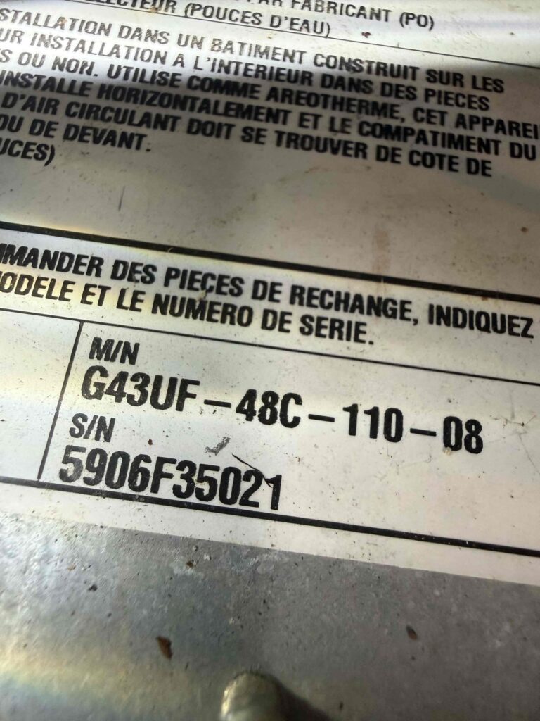 Lennox furnace data plate showing the model and serial numbers used to find its age