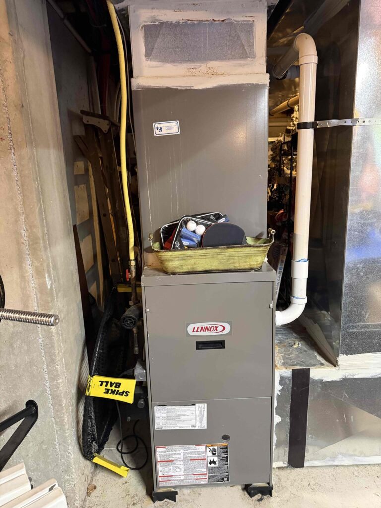 Older Lennox furnace installed in a home utility area