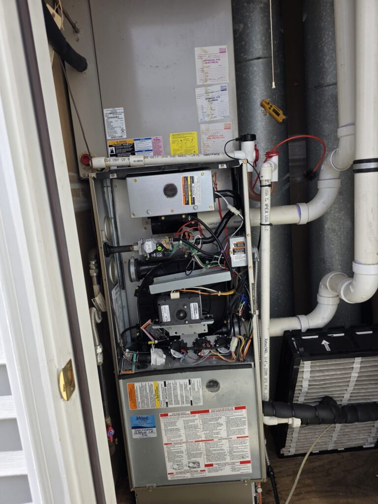 Open furnace cabinet during a heating repair in Washington Township, NJ