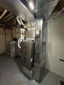 Carrier gas furnace and evaporator coil installed in a basement in Millville, NJ.