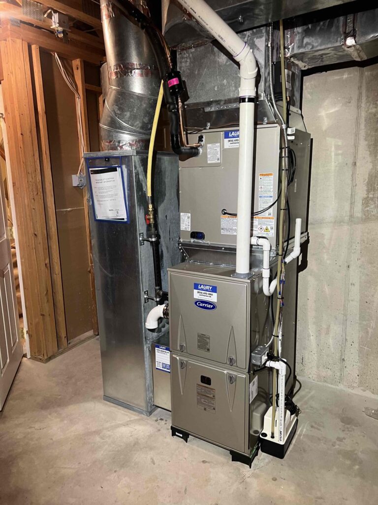 Carrier gas furnace and evaporator coil installed in a basement in South Jersey.