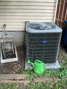 Front view of the new Carrier air conditioner on its outdoor equipment pad