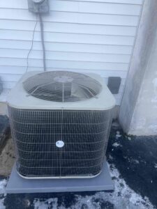 WeatherMaker outdoor air conditioner on a new equipment pad beside a Buena home.