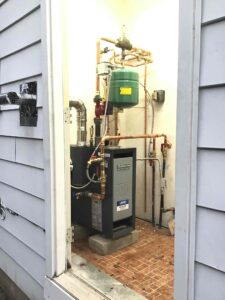 Alt text: Weil-McLain gas boiler installed in an exterior utility closet on North Delsea Drive in Clayton, NJ.