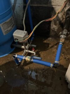 Well pressure tank, pressure switch, and connected water lines at an East Canal Street home in Alloway Township.