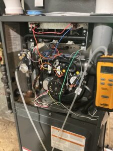 Open furnace cabinet showing corrosion on internal gas piping before replacement in Alloway Township.