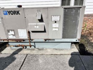 Older YORK packaged HVAC unit with rust along its base at Richwood United Methodist Church