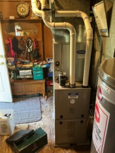 Gas furnace with white vent pipes and overhead ductwork at a home on East Sherman Ave in Vineland.