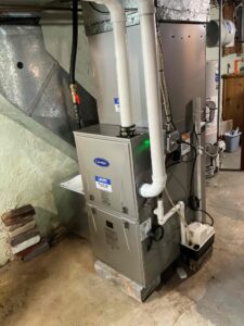 New Carrier gas furnace with PVC venting and a condensate pump in an Alloway Township basement.